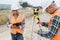 Construction workers setting equipment in the middle of the road structure