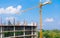 Construction workers site and building of housing at laborer work outdoor which has tower crane blue sky background with copy sp