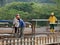 Construction workers are spraying liquid concrete onto the slope surface to form a retaining wall layer.