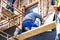 Construction workers thermally insulating house facade with glass wool.