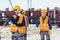 Construction workers in uniform standing outside, examining the