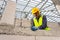 Construction workers use a hammer to hammer a concrete nail into a lightweight concrete block to build a house