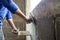 Construction workers use plaster trowel to build cement walls.