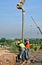 Construction Workers Using Concrete Hose from Concrete Pump