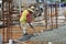 Construction Workers Using Concrete Vibrator