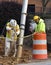 Construction workers vacuum mud from drainage pipe