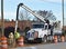 Construction workers vacuum mud from drainage pipe