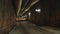 Construction workers walking into a large tunnel