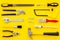 Constructor desk with set of building implements and brushes yellow background top view pattern