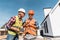 Constructors in helmets standing near houses