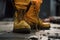 A constuction worker is wearing leather safety shoe, standing on the sand ground at construction working site image