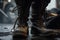 A constuction worker is wearing leather safety shoe, standing on the sand ground at construction working site image