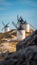 Consuegra windmills in a row with unrecognizable tourists