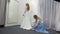 The consultant helps the future bride to choose wedding dress