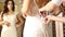 The consultant helps the young woman try a wedding dress. Girl happy to selected wedding dress. young bride makes selfie