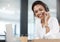 Consultant, portrait of woman with headset and with laptop at her desk in a office of her workplace. Customer service or