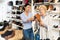 Consultant in shoeshop helping old woman to choose footwear
