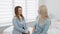 Consultation session: In the calm interior of the spa clinic, a professional cosmetologist consults with a woman, where