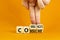 Consume or communicate symbol. Concept word Consume or Communicate on wooden cubes. Beautiful orange table orange background.