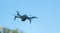 Consumer drone with camera hovering against sky with copy space