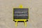 Consumer onboarding symbol. Concept words Consumer onboarding on black chalk blackboard on a beautiful sand beach background.