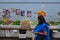 A consumer purchasing fresh produce passing by a long table full of vegetables