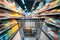 Consumer scene Blurred shopping cart in a busy supermarket department