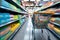 Consumer scene Blurred shopping cart in a busy supermarket department