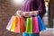 Consumerism woman holding many shopping bags in fashion boutique