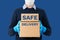Contact less delivery concept, safe shipment, courier in a protective mask and rubber gloves with carboard box, order from online