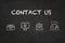 `Contact` text and icons on a blackboard.