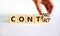 From contact to contract symbol. Businessman turns a wooden cube and changes the word contact to contract. Beautiful white