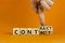 From contact to contract symbol. Businessman turns wooden cubes and changes the word `contact` to `contract`. Beautiful orange