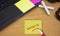 Contact Us sticky note pasted on the office table at the office