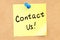 Contact us text on a sticky note pinned