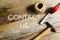 Contact us written on wooden background. Carpentry concept with rope,hammer and measuring tape