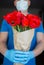 Contactless delivery of a bouquet of beautiful red tulips