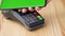 Contactless payment with your smartphone with green mock-up screen. Wireless payment concept. Close-up, woman using