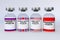 Container bottles with american, chinese,russia and british vaccine mRNA-1273, chadox1 ncov-19,sputnik-v,coronavac  in the treatme