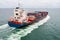 container cargo ship sailing full speed in green sea to transport of goods import export internationally or worldwide as business