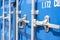 Container close-up. Blue cargo container with a lock. The concept of the increased cost of freight. Banner with place