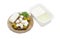 Container of feta and sliced cheese and olives on saucer
