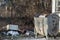 A container full of garbage near a recycling area