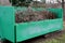 Container of green color for garden waste. it is weighed for bio composting or for thermal use as wood chips. The street and lawn