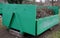 Container of green color for garden waste. it is weighed for bio composting or for thermal use as wood chips. The street and lawn