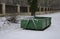 Container of green color for garden waste. it is weighed for bio composting or for thermal use as wood chips. The street and lawn