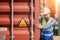 container logistic operators workers wearing yellow helmets and reflection shirts and open containers for inspection and check the