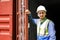 container logistic operators workers wearing yellow helmets and reflection shirts and open containers for inspection and check the