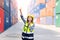 Container operators women wearing helmets and safety vests control via walkie-talkie workers in container yards. Cargo Ship Import