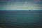 Container ship at anchor on the horizon